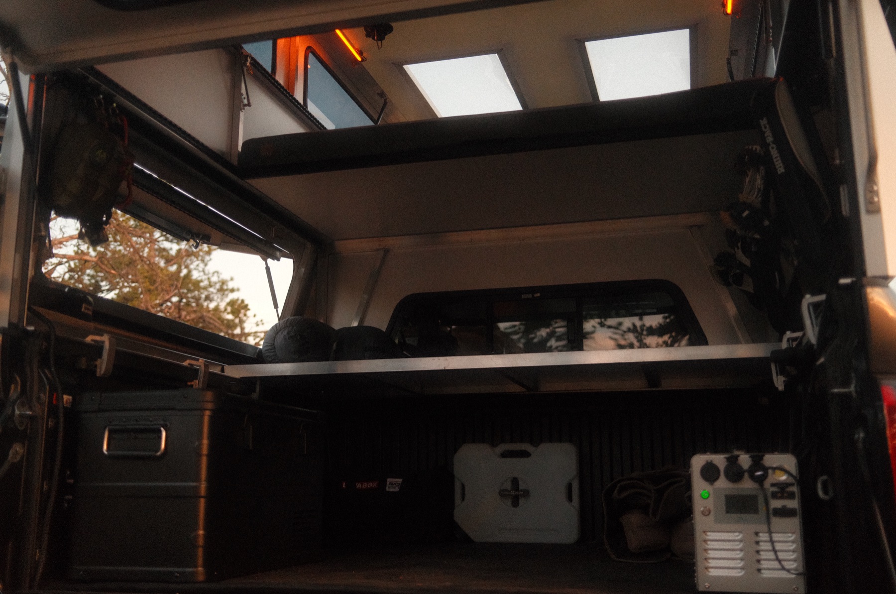 Rear view into the Radica STARGATE with the bed panel raised, showing full truck bed access below