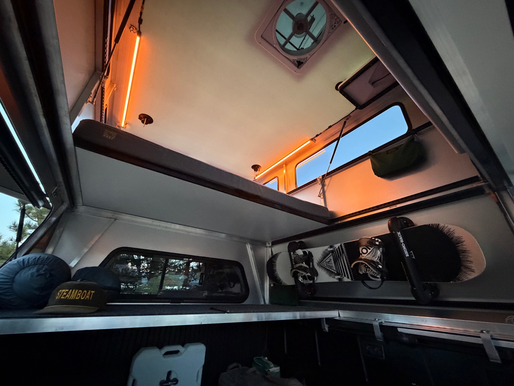 Radica STARGATE interior with a snowboard mounted to the L-Track wall rail and gear stowed below